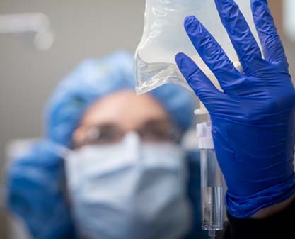 nurse with iv and surgical gloves